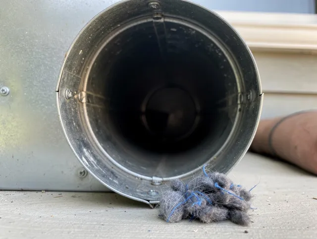 Largo Dryer Vent Cleaning technician using specialized equipment to clear severe dryer vent blockage in Largo
